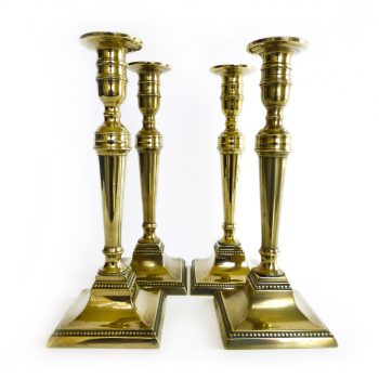 A Rare Set of Four English Brass Candlesticks with Beaded Decoration. Circa 1785.